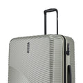 Hard-shell spinner suitcase, light silver-gray, close-up of top handle and side vents