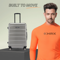 Silver hard-shell suitcase with telescopic handle and 8-wheel base on the move.