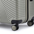 Silver suitcase wheel set with caster wheels and textured ribbed base