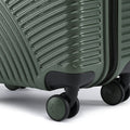 Dark green hard-shell cabin suitcase corner with spinner wheels