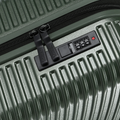 Small cabin suitcase front panel with combination lock and zipper pull on dark green shell.