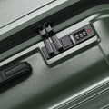 Medium check-in suitcase with TSA-style lock and combination dial on dark green shell
