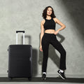 Medium polypropylene hard-shell suitcase in dark black with extended handle and 8 wheels