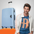Medium polypropylene hard-shell suitcase, light blue, side view with handle and 8 wheels