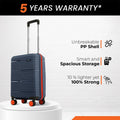 Small cabin suitcase, navy blue hard-shell with upright handle and 8 wheels
