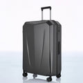 Hard-shell trolley luggage in dark grey with telescopic handle and four spinner wheels.