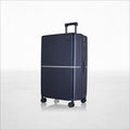 Hard-shell polycarbonate trolley luggage, dark blue, front view with wheels and telescoping handle