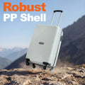 White cabin suitcase with textured shell and four wheels, standing outdoors