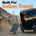 Teal cabin suitcase with 4 wheels lying on street, with telescopic handle up.