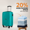 Teal cabin suitcase with telescopic handle and 4 wheels beside stacked clothes