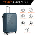 Hard-shell suitcase in teal with four wheels, shown for drop and trolley testing