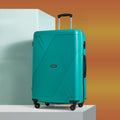 Large polypropylene suitcase in teal close-up with molded shell and side panel