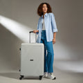 Large polypropylene suitcase in light gray with telescopic handle and 4 wheels
