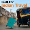 Teal hardshell suitcase with telescopic handle and four spinner wheels on road