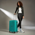 Teal medium 4-wheel suitcase with telescopic handle, pulled by a person