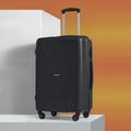 Black medium rolling suitcase with four wheels, ribbed shell, and telescopic handle.