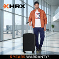 Black medium rolling suitcase with four wheels and telescopic handle.
