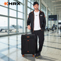 Black soft-sided spinner trolley suitcase with telescopic handle and orange wheels