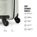 Close-up of light green hard-shell trolley corner with 360-degree spinner wheels
