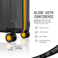 Dark blue polycarbonate trolley suitcase corner with yellow accents, wheels, and smooth rotation