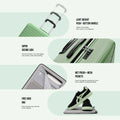 Green cabin spinner suitcase close-up with push-button handle and ribbed shell