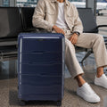 Navy medium check-in trolley with telescopic handle and 8 spinner wheels
