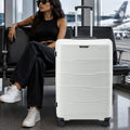 Large check-in trolley with four corner wheels, light grey shell with ridged panels