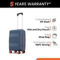 Blue small cabin suitcase with orange trim and 8 wheels on a flat stance