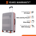 Grey hard-shell suitcase with orange side trim, top handle, and textured front shell