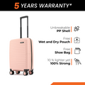 Peach cabin suitcase with black handle and 8 spinner wheels on display.