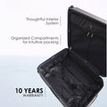 Hard-shell trolley suitcase interior, open with organized compartments and cross ribbon.