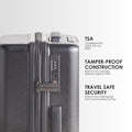 Hard-shell trolley suitcase close-up of TSA combination lock and side release, silver and dark grey