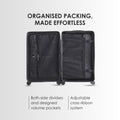 Open dark hard-shell suitcase interior with two compartments and side divider pockets