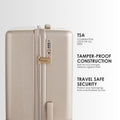 Beige hard-shell trolley suitcase with side lock, TSA panel, and upright handle