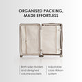 Open beige hard-shell luggage showing two interior dividers and packing pockets