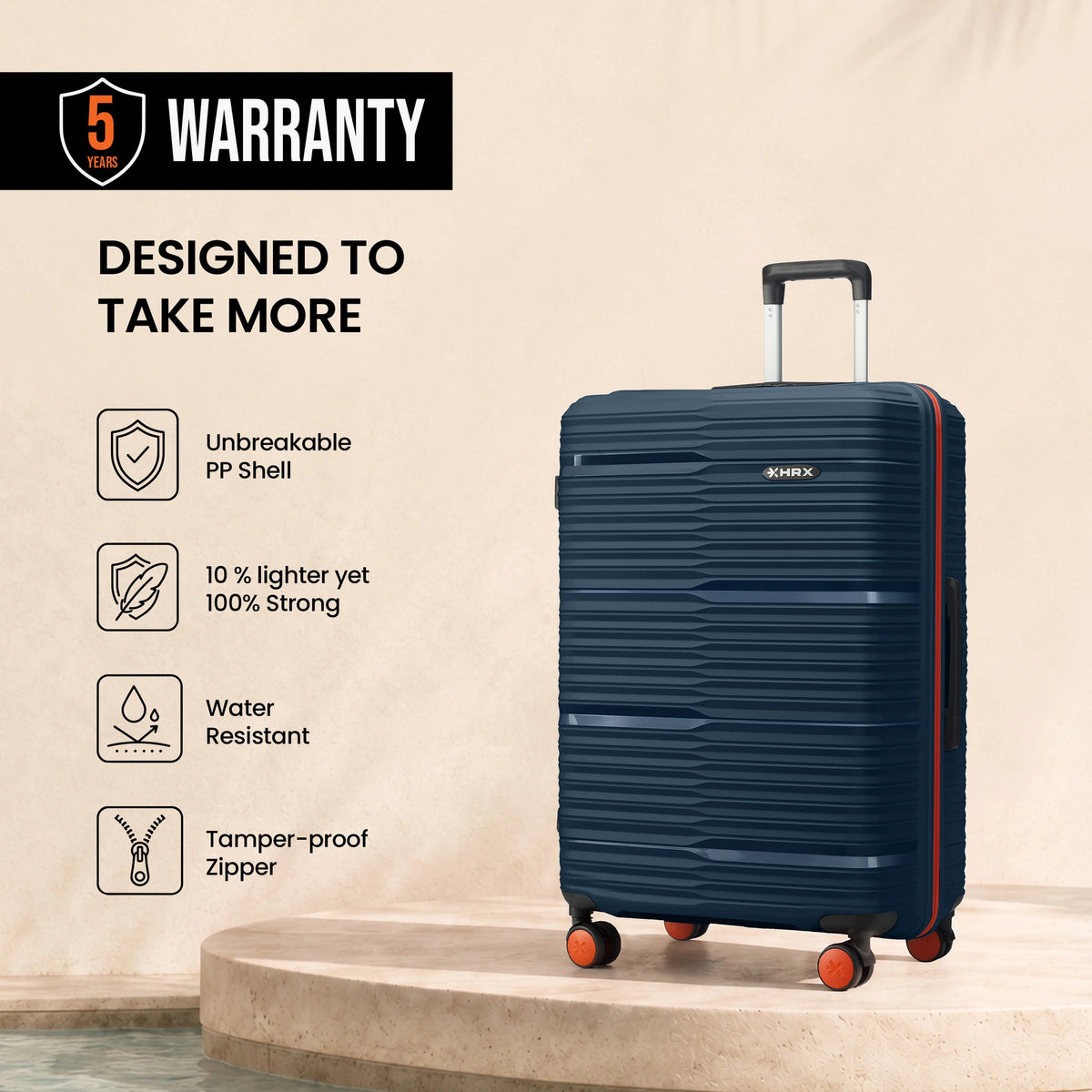 Medium check-in suitcase, dark blue ribbed shell with orange wheel accents