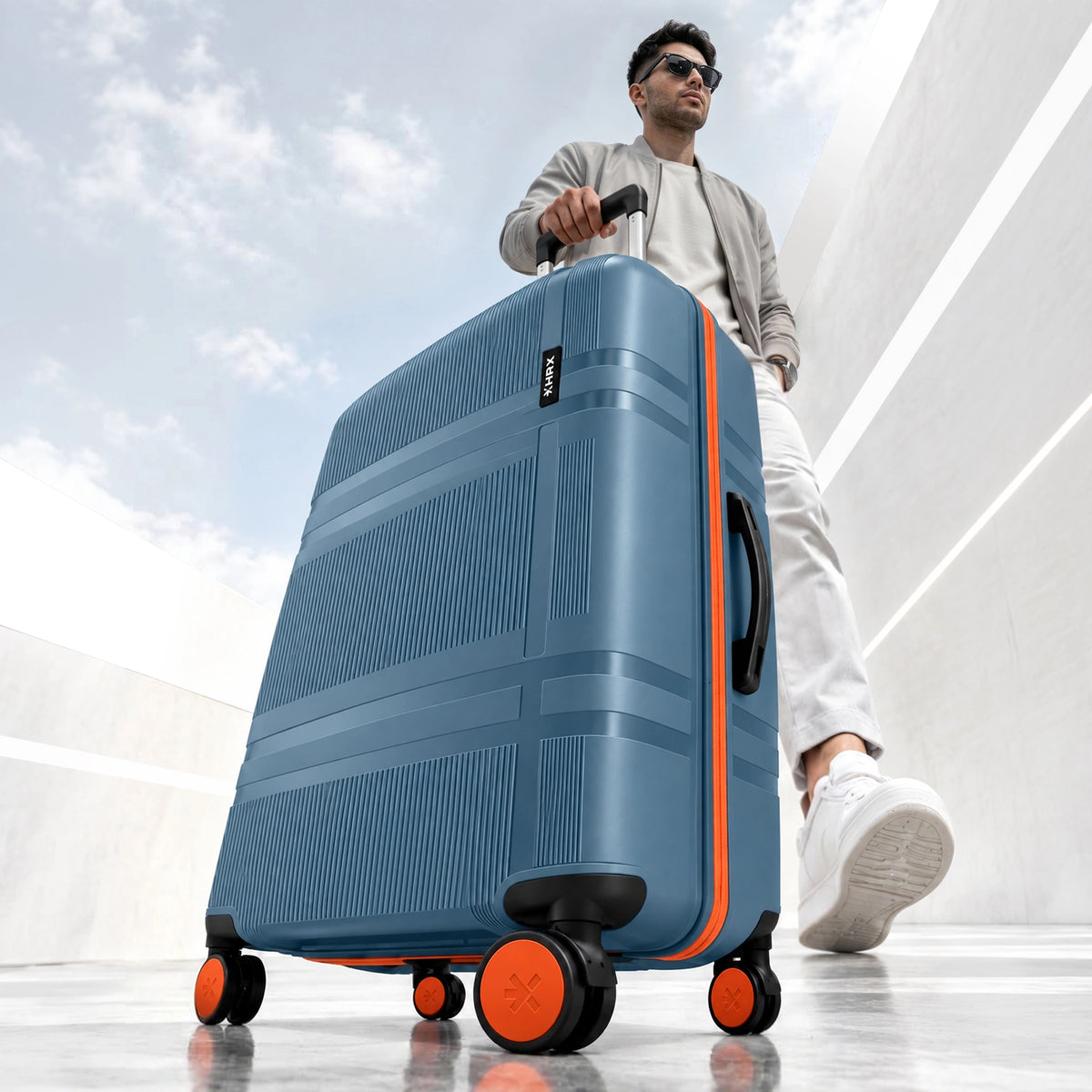 Blue hard-shell carry-on suitcase with telescopic handle and four spinner wheels