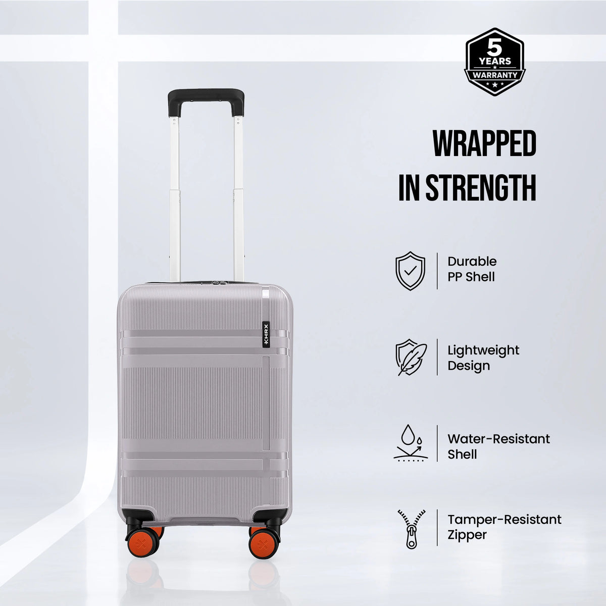 Grey cabin suitcase with telescopic handle, orange-trim accents, and spinner wheels