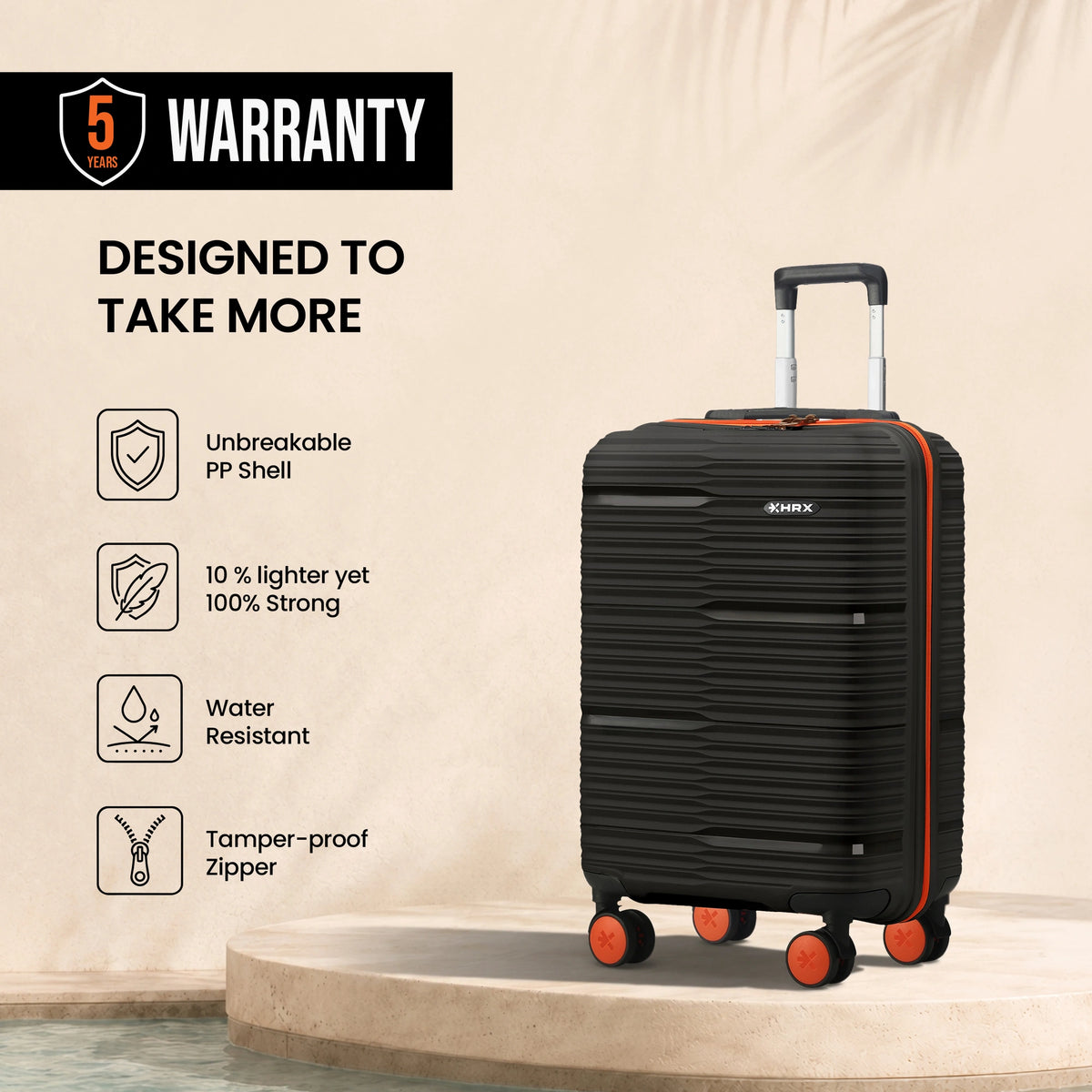 Black small cabin suitcase with ribbed shell, 8 wheels, orange accents and telescopic handle.