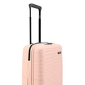 Peach small cabin suitcase with black side handle and textured shell