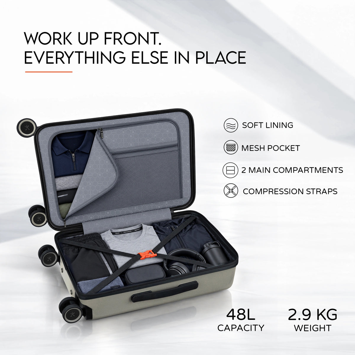 Opened trolley case with grey soft lining, mesh pocket, and compression straps inside.