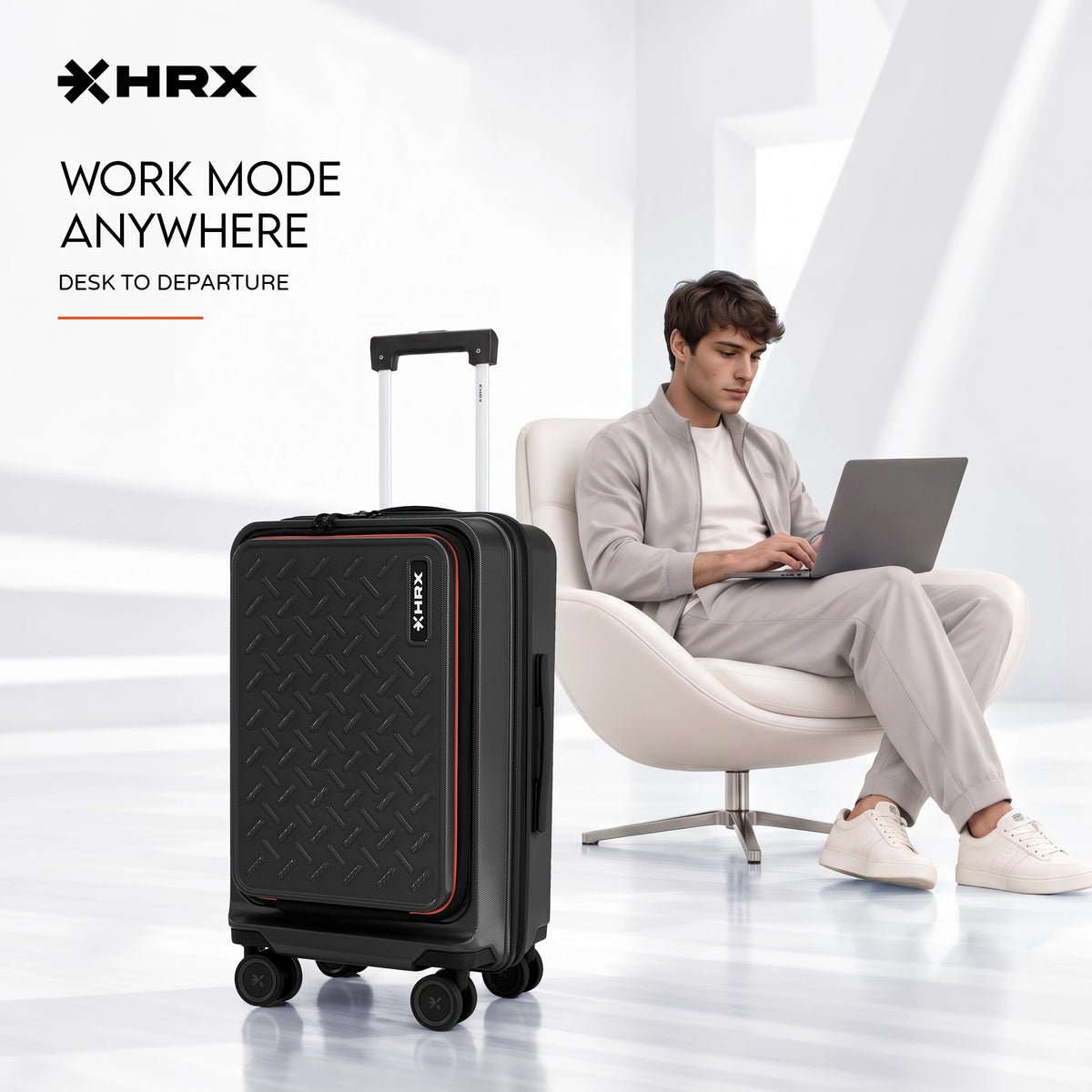 Black hard-shell cabin trolley with front laptop compartment and four spinner wheels