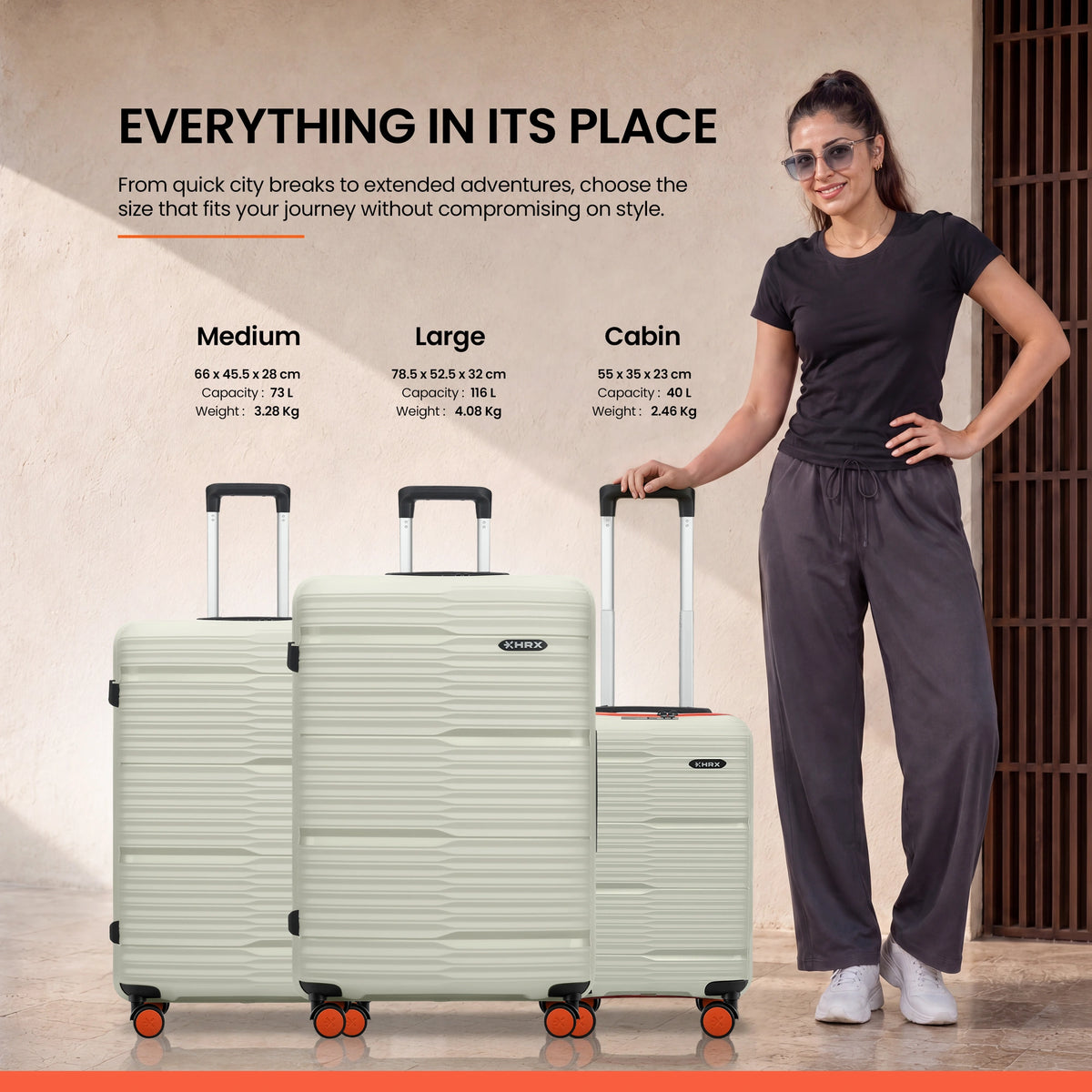 Stacked set of light gray luggage pieces with telescopic handles and spinner wheels