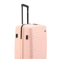 Peach hard-shell luggage, upright with telescopic handle and spinner wheels