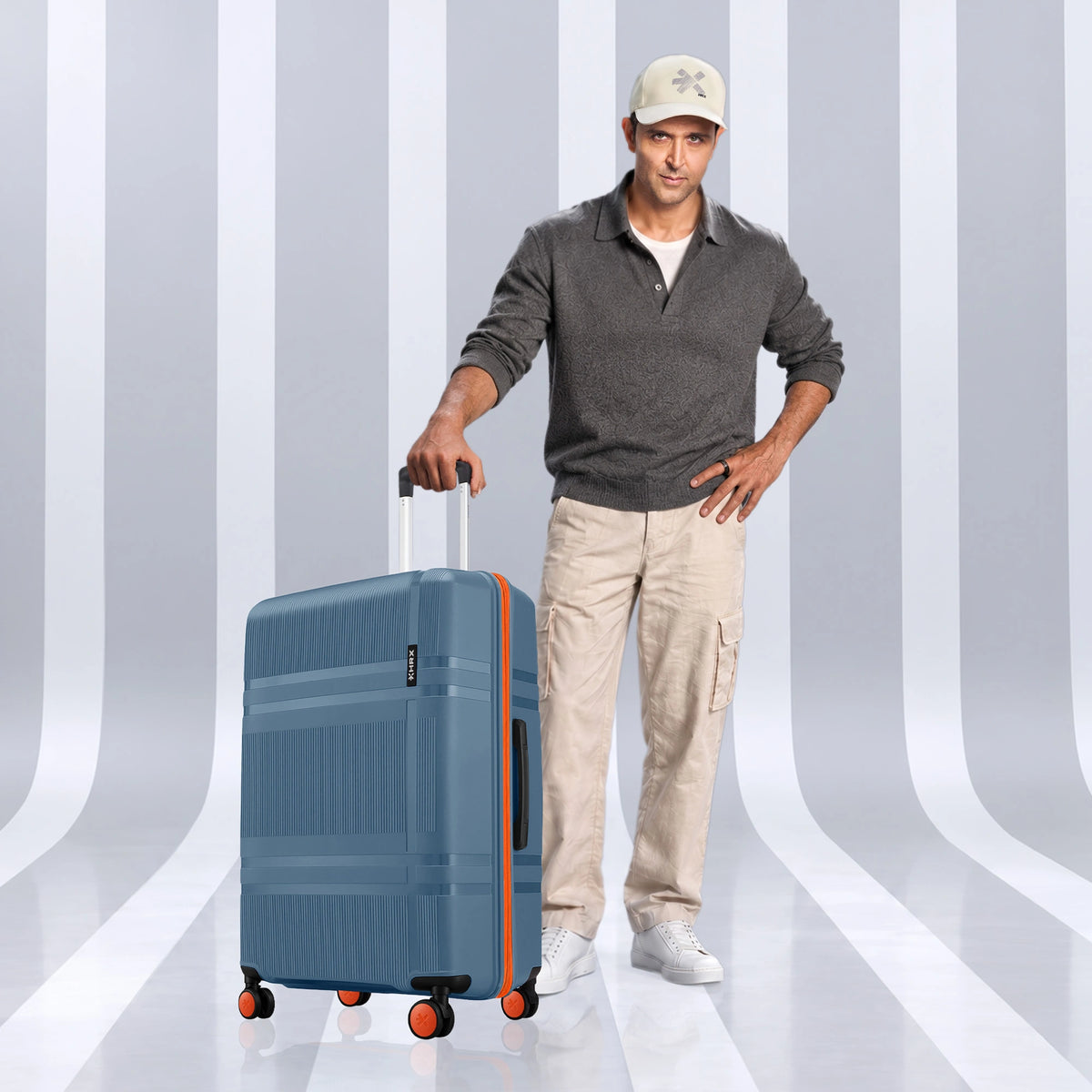 Blue check-in suitcase with telescopic handle and four corner wheels
