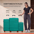 Teal HRX medium check-in suitcase set with upright side profile and standing carry