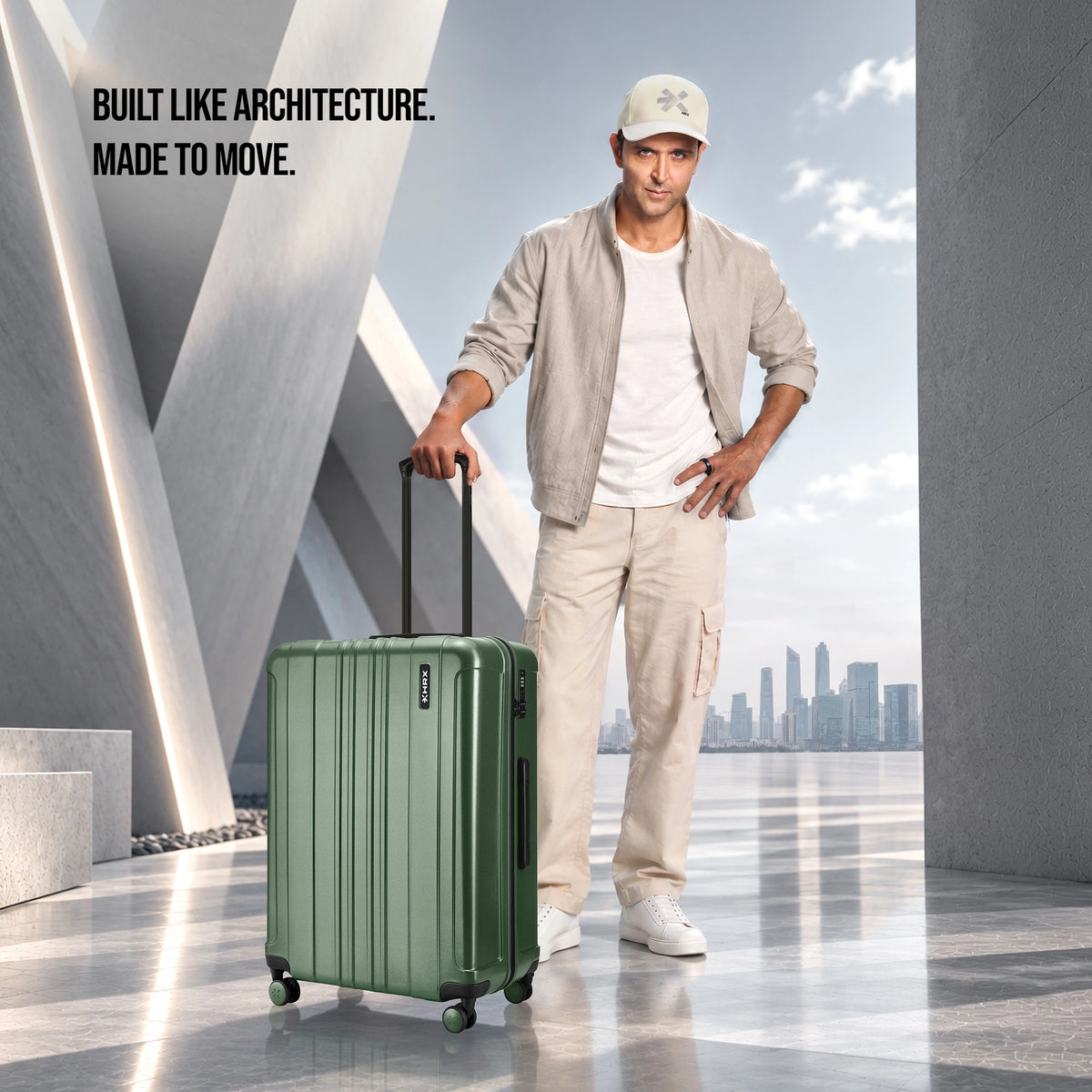 Dark green check-in suitcase with upright handle and spinner wheels, shown with traveler