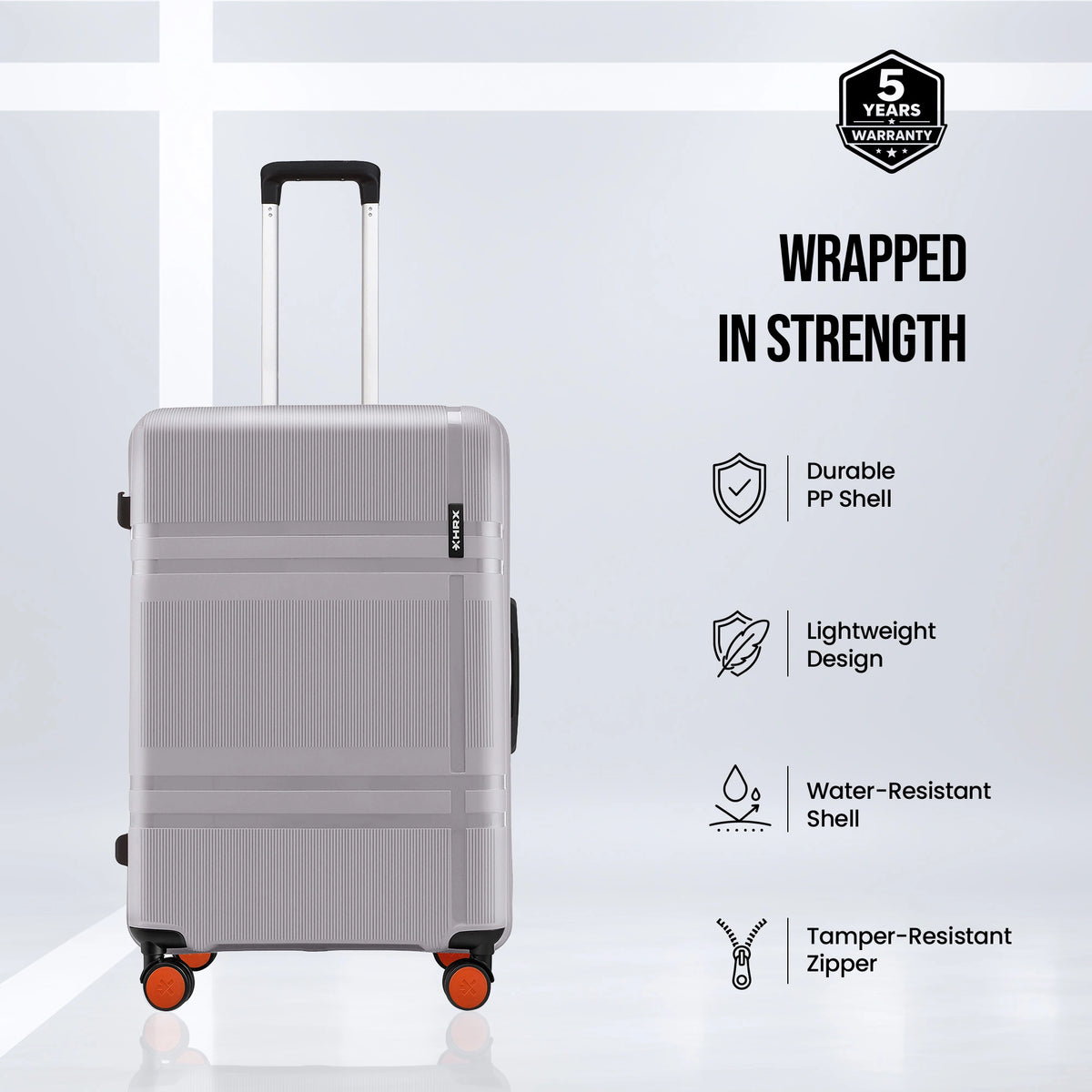 Grey polycarbonate suitcase front view with telescopic handle, 8 wheels, orange accents
