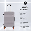 Grey polycarbonate suitcase front view with telescopic handle, 8 wheels, orange accents