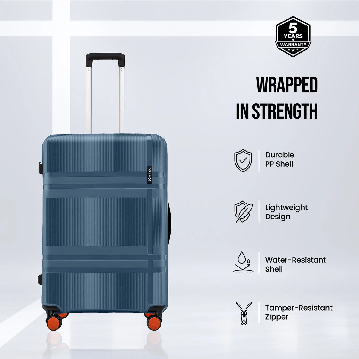 Blue hard-shell suitcase with top handle and four spinner wheels, side view